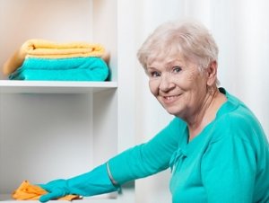 Senior woman cleaning house