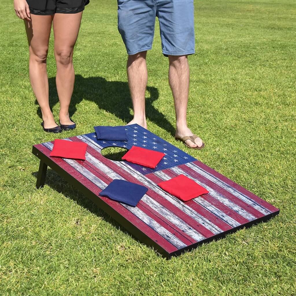 A couple playing Cornhole in the yard