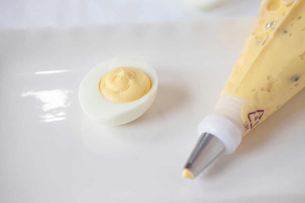 piping bag filling deviled eggs