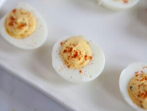 Simple Deviled Eggs sprinkled with paprika on a serving platter